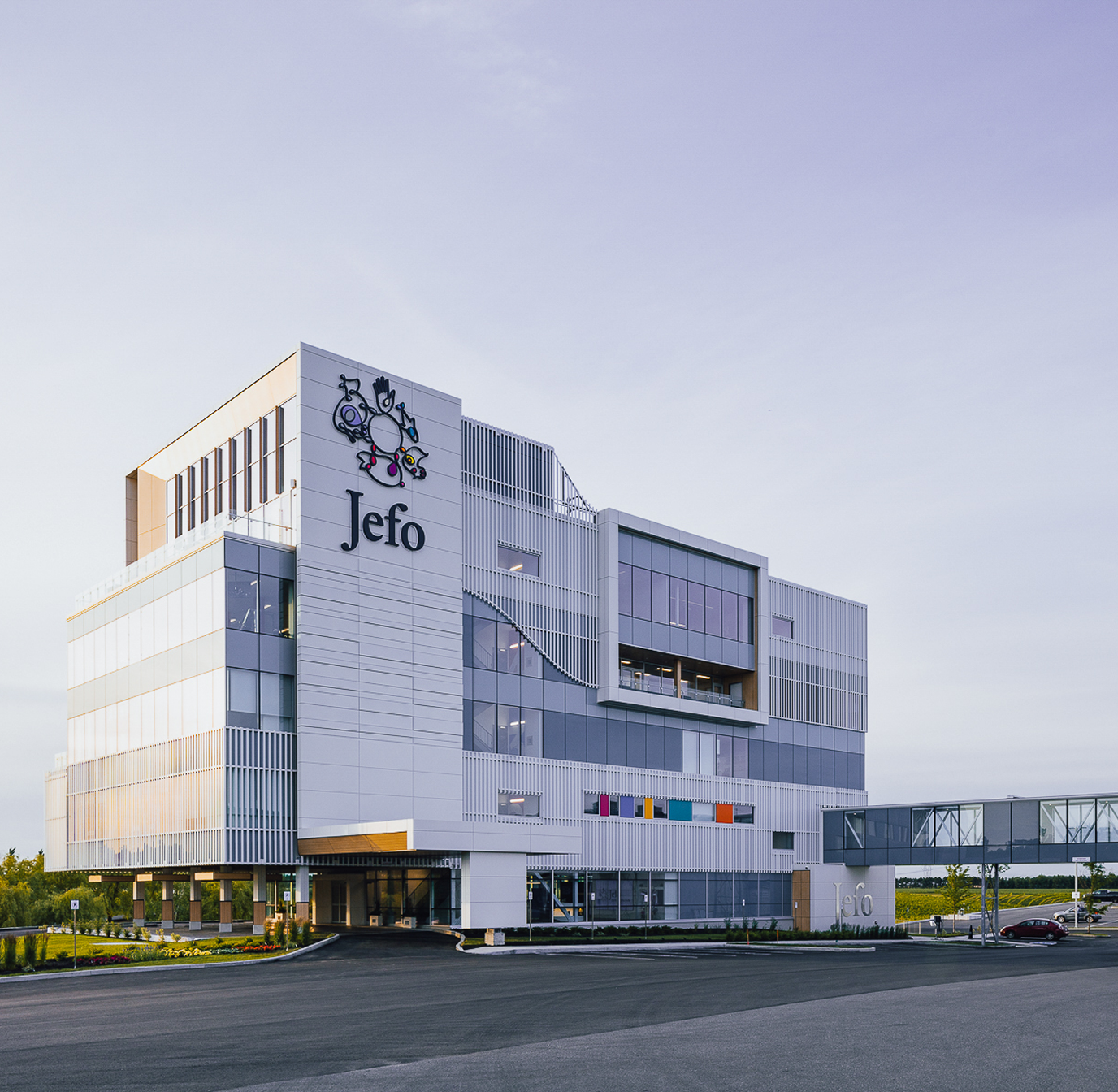 Main Jefo campus building, an innovative company in animal nutrition, under clear morning sky.