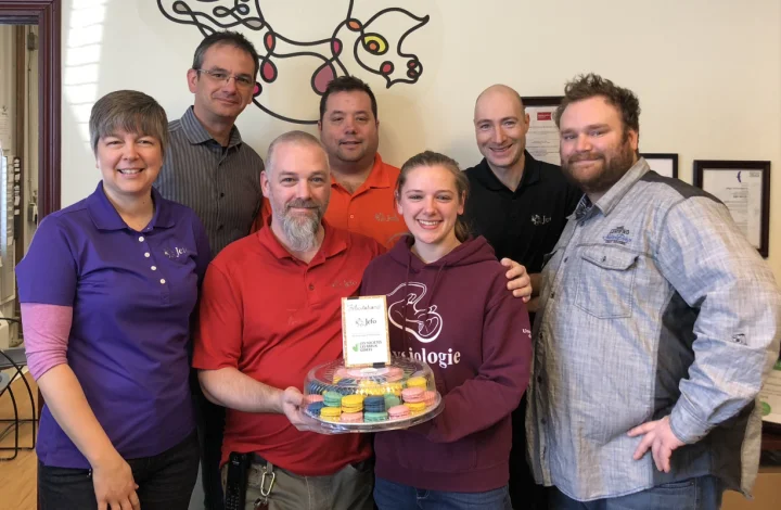 Jefo team celebrating 2019 Gold Standard – Canada’s Best Managed Companies, smiling with colorful macarons.