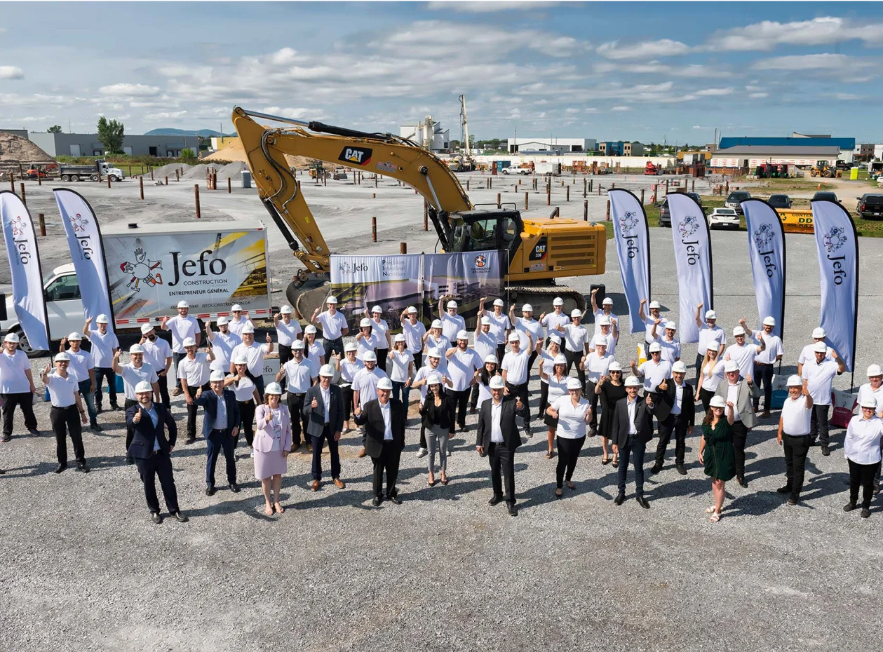 Wide view of the Jefo team gathered at the construction site of the new animal nutrition production facility.