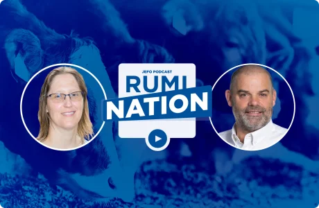 Two animal nutrition experts featured in Rumination S6E4, with calves feeding in the background.