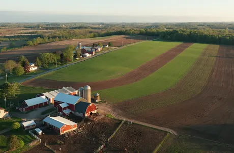 Vista aérea de una granja lechera y sus campos, representando el entorno productivo en nutrición animal.