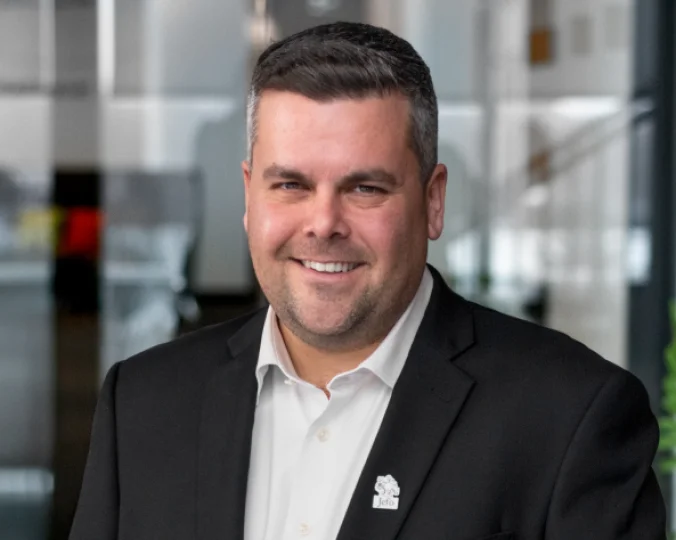 Headshot of Jean-François Fontaine with a black suit, a white shirt and a Jefo pin.