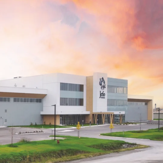 Wide exterior view of the Jefo Technologies building in Saint-Hyacinthe at dawn.