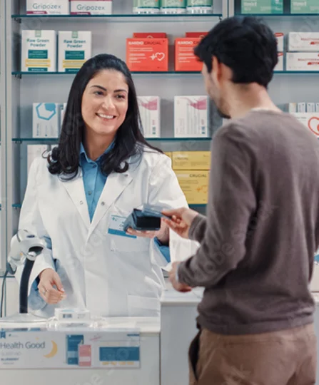 Smiling pharmacist assisting a customer — showcasing health benefits and wellness support at Jefo.